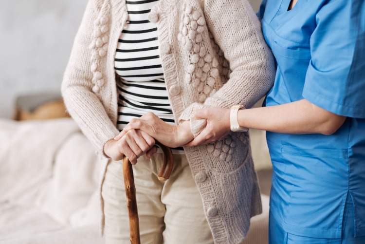 Nursing with senior woman in nursing home